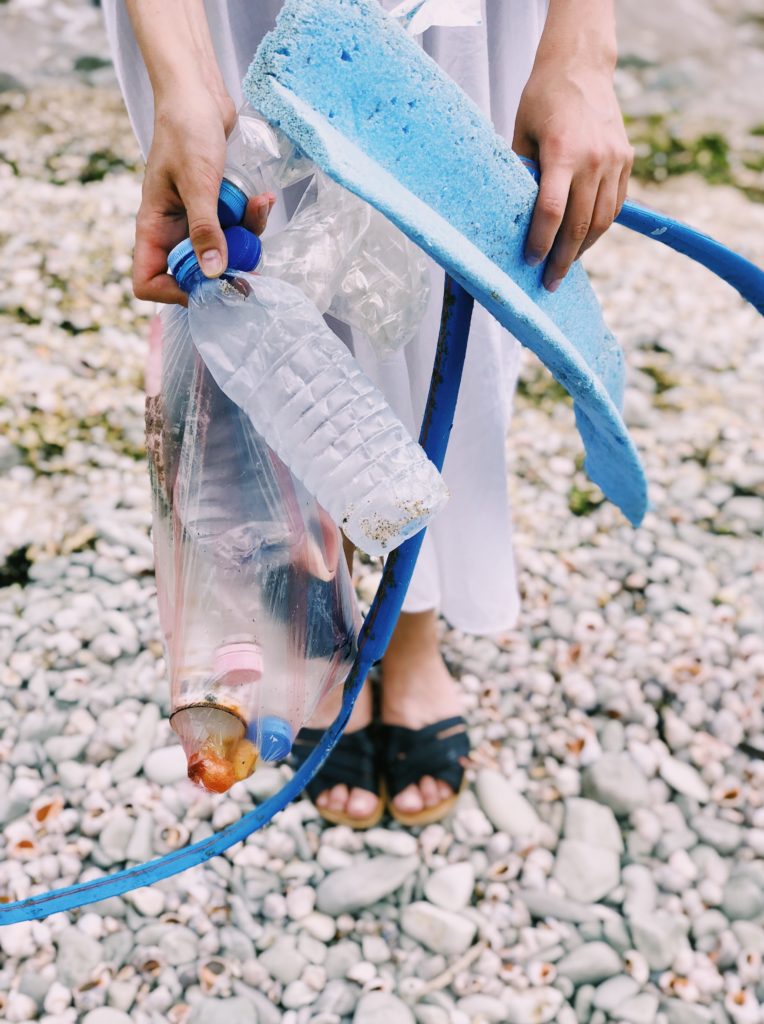 person-holding-plastic-bottles-and-hose-1201589-764x1024 Love Justice